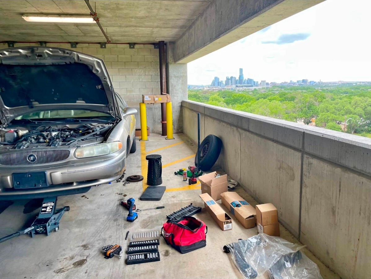 Mobile mechanic performing vehicle repairs in Fort Worth parking garage